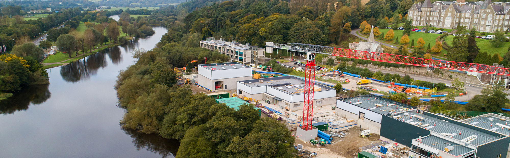 Aerial image of Lee Road Water treatment plant, Cork under construction. River running to the left and cranes and construction site on the right side