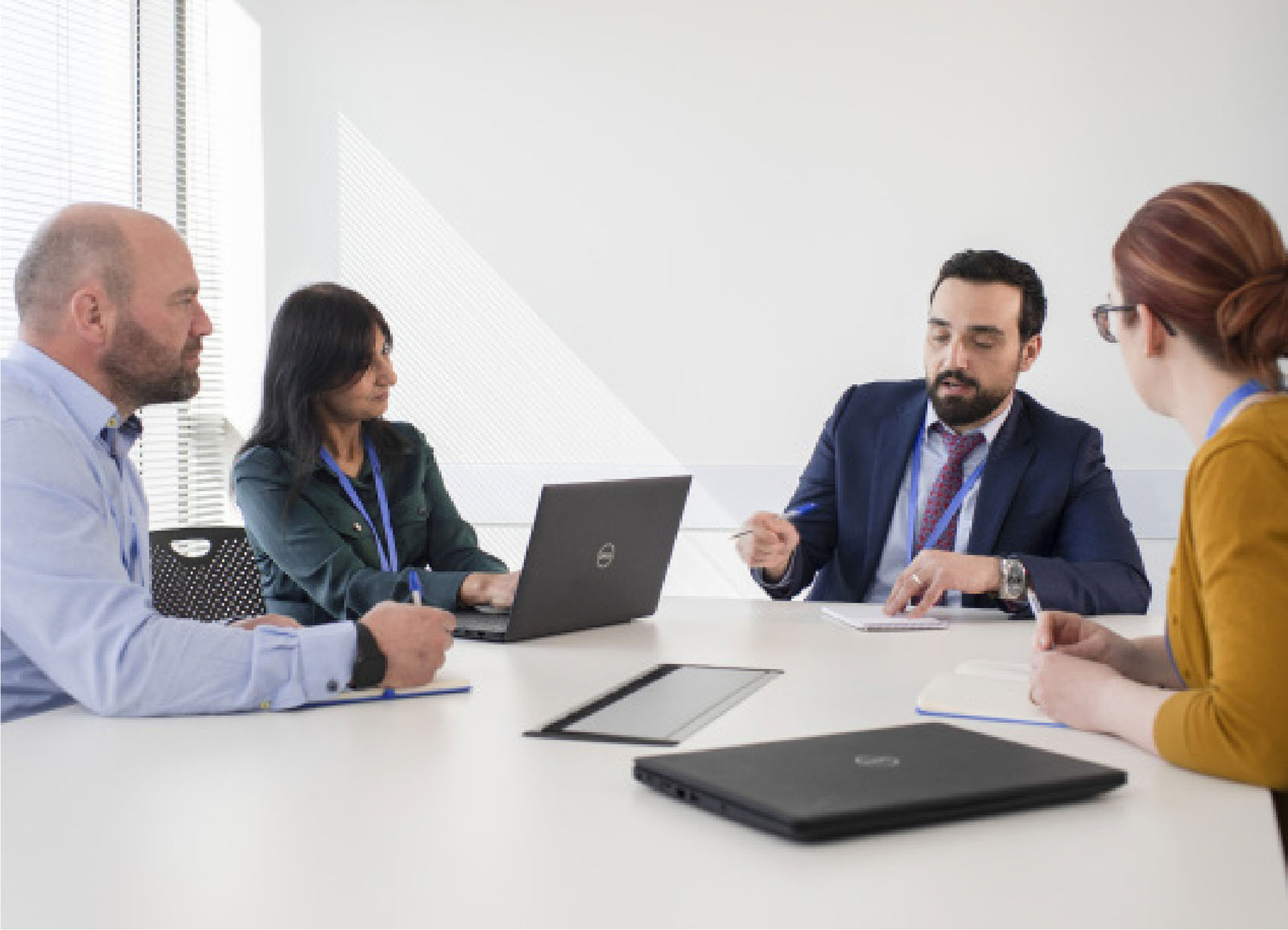 2 male and 2 female Uisce Eireann employees having a discussion in a meeting room 