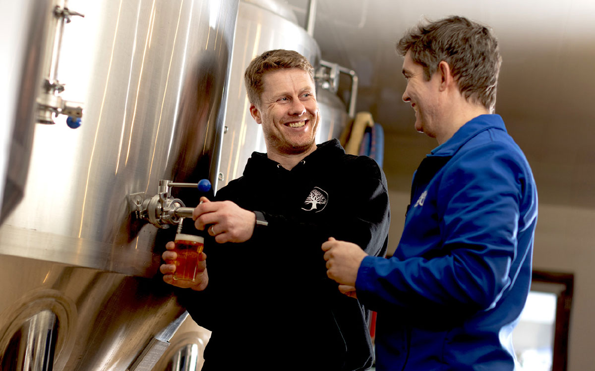 Uisce Eireann representative smiling with brewery owner