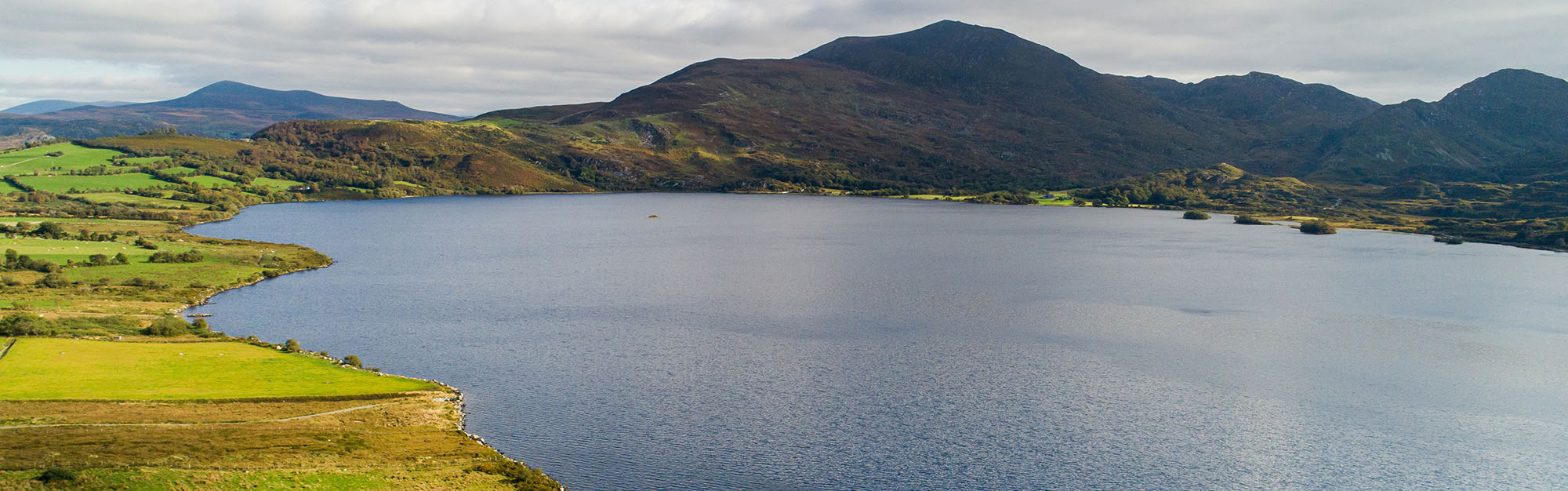 Lough Guitane, Kerry - aerial drone shot of the lough with mountains in the background