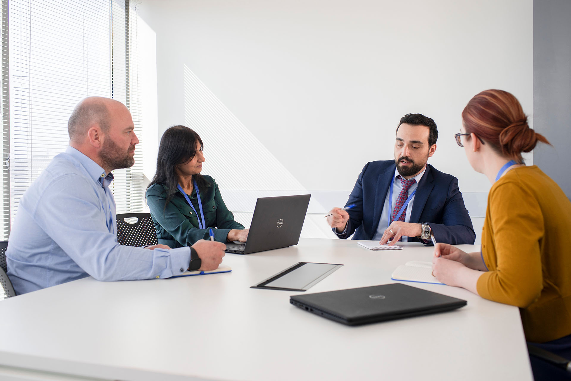 Four people having a meeting in a room