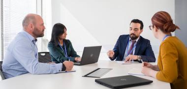Four people having a meeting in a room