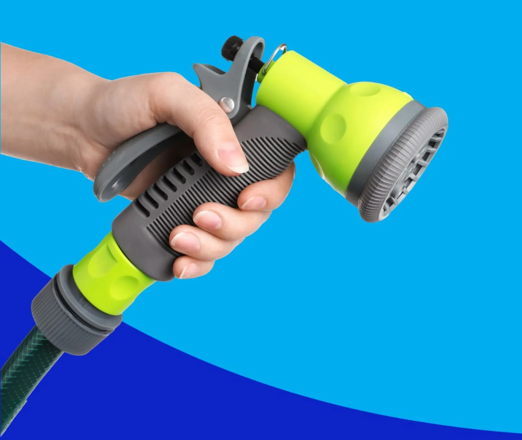 A person holding a green garden hose