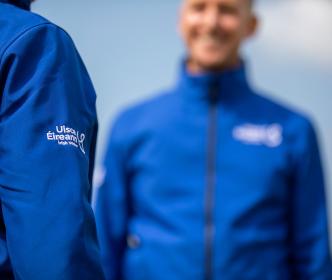 Two Uisce Éireann employees wearing blue full zips tops