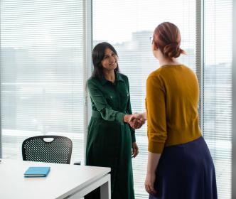 Two office workers shaking hands