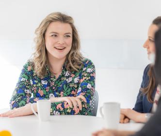 Employees sharing cups of tea and coffee in the canteen