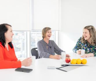 UÉ employees laughing together in the canteen