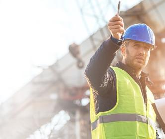 two Uisce Éireann workers pointing at something on site 