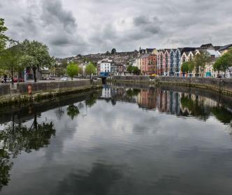 A river by a row of colourful houses