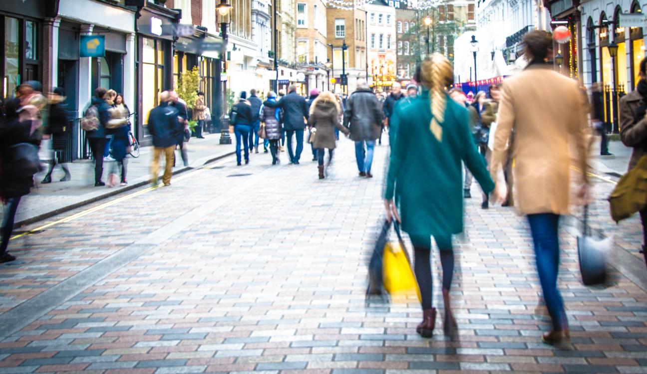 A blurry image of a retail street